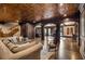Spacious living area with detailed ceiling, hardwood floors, bar area, and comfortable seating at 833 Hines Rd, Moreland, GA 30259