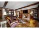 Cozy living room with brick fireplace, built-in bookshelves, and an oversized leather sectional at 833 Hines Rd, Moreland, GA 30259