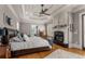 Beautiful main bedroom features a fireplace, trey ceilings, and hardwood flooring at 833 Hines Rd, Moreland, GA 30259