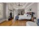 Bright, expansive bedroom with a fireplace, hardwood floors, and decorative tray ceiling at 833 Hines Rd, Moreland, GA 30259