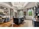 Sophisticated office featuring a large desk, coffered ceilings, chandelier, and multiple windows with views at 833 Hines Rd, Moreland, GA 30259