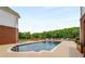 Enjoy a private pool with sprawling greenspace and a luxurious white brick home in the background at 833 Hines Rd, Moreland, GA 30259