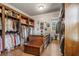 Large walk-in closet features custom shelving, storage island, and hardwood floors at 833 Hines Rd, Moreland, GA 30259