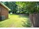 Large backyard featuring a privacy fence, mature trees, and a storage shed at 3464 Navaho Se Trl, Smyrna, GA 30080