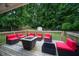 Cozy backyard deck with a fire pit and comfortable seating, surrounded by lush greenery at 3464 Navaho Se Trl, Smyrna, GA 30080