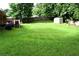 Expansive backyard featuring lush green lawn, storage sheds, and a wooden fence providing privacy at 3464 Navaho Se Trl, Smyrna, GA 30080