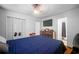 A cozy bedroom features white walls, louvred closet doors, a flat screen tv, and an ensuite bath at 3464 Navaho Se Trl, Smyrna, GA 30080