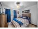 Cozy bedroom featuring a ceiling fan, a comfortable bed, blue curtains, and modern decor at 3464 Navaho Se Trl, Smyrna, GA 30080