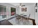 Bright dining area featuring a glass-top table, decorative rug, and sliding doors to an outdoor deck at 3464 Navaho Se Trl, Smyrna, GA 30080