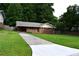 Charming brick home with long driveway, mature trees, and well-manicured lawn at 3464 Navaho Se Trl, Smyrna, GA 30080