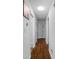 Long hallway with hardwood floors and white doors leading to various rooms in the home at 3464 Navaho Se Trl, Smyrna, GA 30080