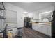 Bright kitchen features white cabinets and countertops, updated appliances, and vinyl flooring at 3464 Navaho Se Trl, Smyrna, GA 30080