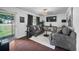 Cozy living room with hardwood floors, comfortable seating, and ample natural light at 3464 Navaho Se Trl, Smyrna, GA 30080