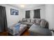 Comfortable gray living room with sectional sofa, decorative pillows, and hardwood floors at 3464 Navaho Se Trl, Smyrna, GA 30080