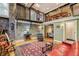 Cozy living room featuring exposed brick, metal railings, hardwood floors, and open access to other rooms at 685 Argonne Ne Ave # 15, Atlanta, GA 30308