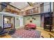 This living room features a red leather sofa, spiral staircase, and lofted dining room view at 685 Argonne Ne Ave # 15, Atlanta, GA 30308