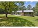 View of the home's back exterior showing the large yard and patio space at 146 Pine St, Covington, GA 30014