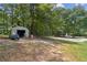 Large backyard with mature trees and out building at 146 Pine St, Covington, GA 30014