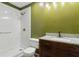 Bathroom featuring tiled shower, vanity with granite counter, and modern fixtures at 146 Pine St, Covington, GA 30014