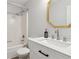 Bathroom features an octagonal mirror, vanity and shower-tub combination at 146 Pine St, Covington, GA 30014