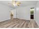 Bright bedroom features neutral colors, vinyl flooring and a ceiling fan at 146 Pine St, Covington, GA 30014