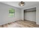Bright bedroom with wood floors, open closet, and modern ceiling fan at 146 Pine St, Covington, GA 30014