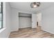 Bright bedroom with wood floors and open closet, ready for your personal touches at 146 Pine St, Covington, GA 30014