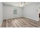 This bedroom features modern vinyl plank flooring, light gray walls, and a ceiling fan at 146 Pine St, Covington, GA 30014