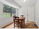 Cozy eat-in kitchen with a wooden table, a big window, and tiled floors at 146 Pine St, Covington, GA 30014