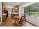 Bright eat-in kitchen with a wooden table, a large window, and tiled floors at 146 Pine St, Covington, GA 30014