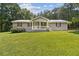 Charming single-story home with covered front porch and large front yard at 146 Pine St, Covington, GA 30014