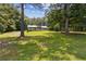 Single-story house with a big lawn, partially framed by trees under a cloudy sky at 146 Pine St, Covington, GA 30014