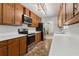 Galley style kitchen with stainless steel oven and microwave appliances and ample counter space at 146 Pine St, Covington, GA 30014