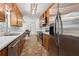 Well-lit kitchen featuring stainless steel appliances, a double sink, and an adjacent dining area at 146 Pine St, Covington, GA 30014