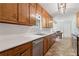 Classic kitchen with stainless steel dishwasher, double sinks, and an adjacent dining area at 146 Pine St, Covington, GA 30014