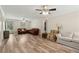 Open living room with hardwood style floors, neutral paint, and multiple seating areas at 146 Pine St, Covington, GA 30014