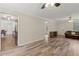 View of the open living room, adjacent to the kitchen, offering hardwood style floors at 146 Pine St, Covington, GA 30014