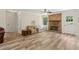 Bright living room with a brick fireplace, wood floors, ceiling fan, and comfortable seating at 146 Pine St, Covington, GA 30014