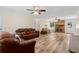 Cozy living room featuring a brick fireplace and wood flooring at 146 Pine St, Covington, GA 30014