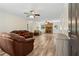 Spacious living room with wood floors, a brick fireplace, and a ceiling fan at 146 Pine St, Covington, GA 30014