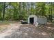 Features outbuilding with storage surrounded by a wooded lot for your outdoor activities at 146 Pine St, Covington, GA 30014