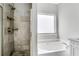 Bathroom showcasing a tiled shower and separate soaking tub at 2005 Chicago Nw Ave, Atlanta, GA 30314