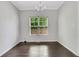 Dining room featuring wood floors, trim, chandelier, and natural light from the window at 2005 Chicago Nw Ave, Atlanta, GA 30314