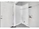 Small laundry room with wire shelves, white door and white walls at 2005 Chicago Nw Ave, Atlanta, GA 30314