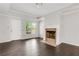 Bright living room featuring hardwood floors, crown molding, a fireplace, and natural light at 2005 Chicago Nw Ave, Atlanta, GA 30314