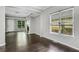 Bright living room featuring hardwood floors, large windows, and access to the fireplace at 2005 Chicago Nw Ave, Atlanta, GA 30314