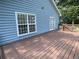 Exterior of home with a private deck with a wood railing, and blue siding at 1833 Phillips Ave, East Point, GA 30344