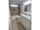 Bathroom with updated tile shower, granite countertop and white cabinets at 1833 Phillips Ave, East Point, GA 30344