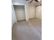 Bedroom showcasing a barn door, closet, ceiling fan, neutral walls, and plush carpeting at 1833 Phillips Ave, East Point, GA 30344