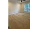 A light-filled bedroom features a ceiling fan, neutral walls, a large window, and plush carpeting at 1833 Phillips Ave, East Point, GA 30344